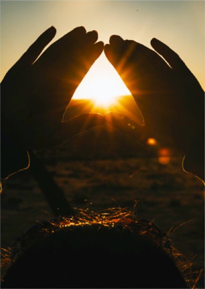 Sunset through hands